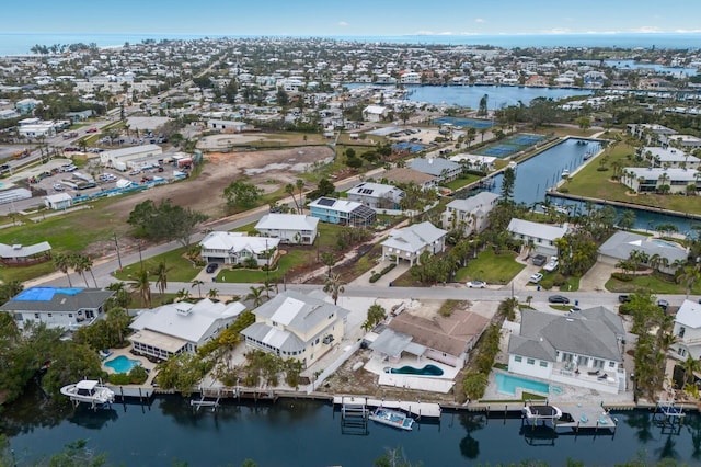 drone / aerial view with a residential view and a water view