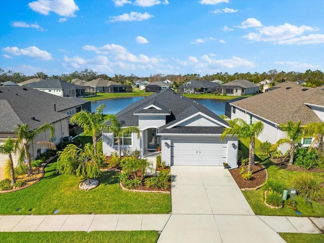 ranch-style house featuring a water view, an attached garage, a front yard, a residential view, and driveway