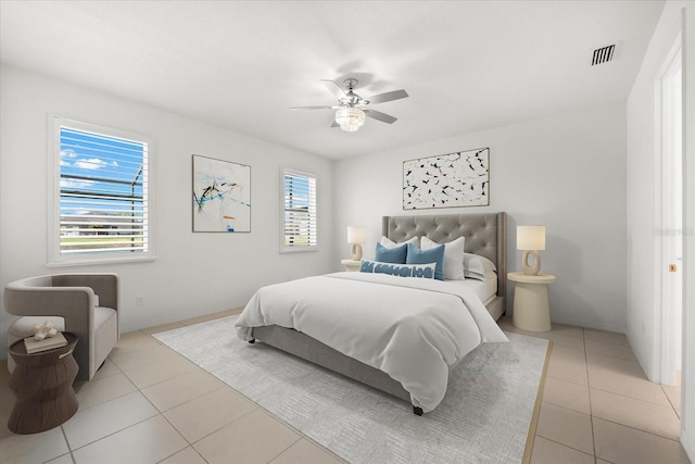 bedroom with multiple windows, visible vents, and light tile patterned flooring