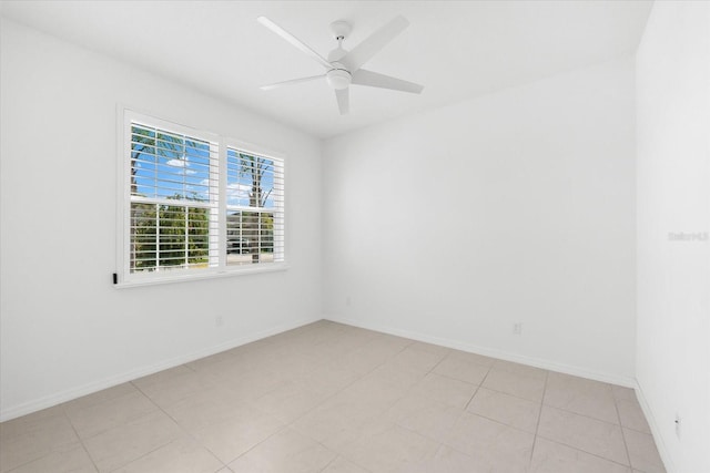 empty room with ceiling fan and baseboards