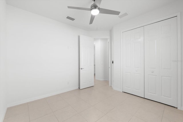 unfurnished bedroom featuring baseboards, visible vents, ceiling fan, and a closet