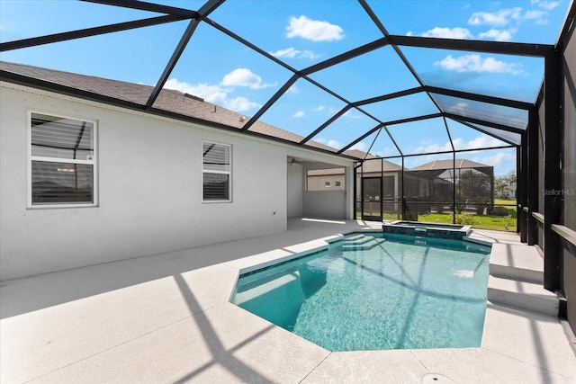 view of pool featuring a lanai, a pool with connected hot tub, and a patio