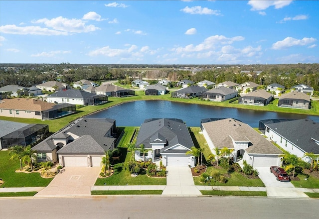 drone / aerial view with a water view and a residential view