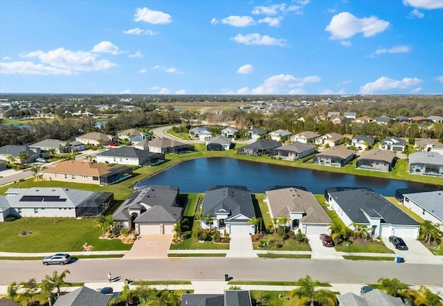 drone / aerial view with a residential view and a water view