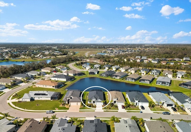 drone / aerial view with a residential view and a water view