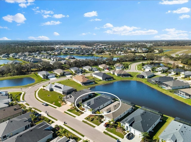 birds eye view of property with a water view and a residential view