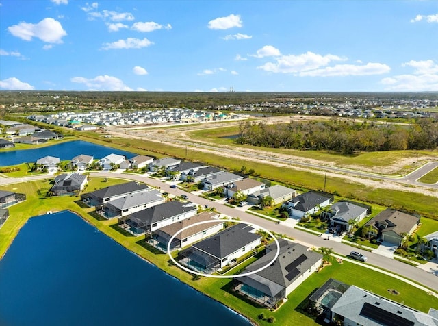 bird's eye view featuring a residential view and a water view