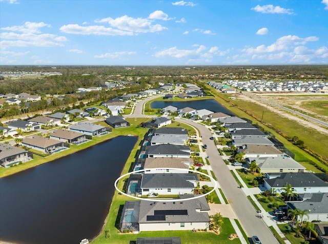 bird's eye view with a residential view and a water view