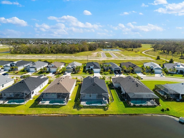 drone / aerial view with a residential view and a water view