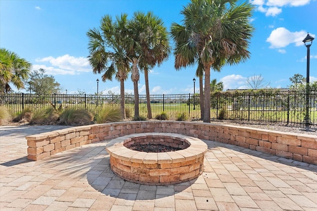 view of patio / terrace with an outdoor fire pit and fence