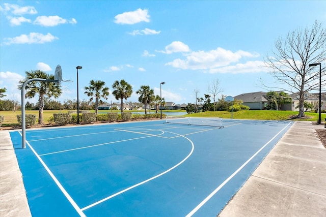 view of basketball court with community basketball court and a lawn