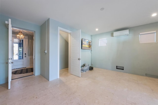 basement with recessed lighting, a wall unit AC, and tile patterned floors