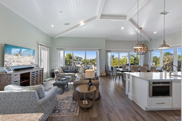 living area with wooden ceiling, dark wood finished floors, lofted ceiling with beams, and an inviting chandelier