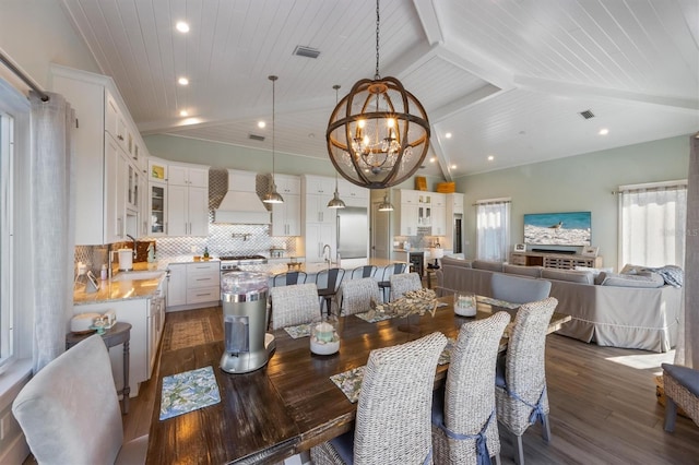 dining area featuring vaulted ceiling with beams, dark wood-style flooring, wooden ceiling, and a wealth of natural light