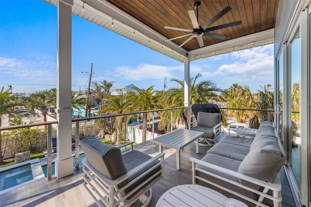 wooden terrace with an outdoor hangout area and ceiling fan