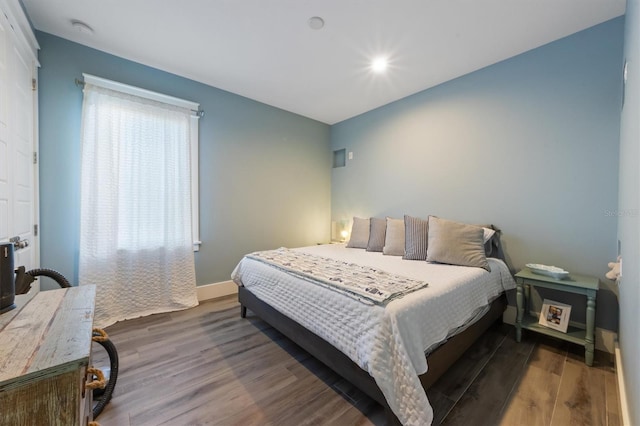 bedroom featuring baseboards and wood finished floors