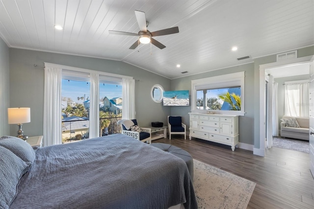 bedroom with baseboards, visible vents, vaulted ceiling, and wood finished floors