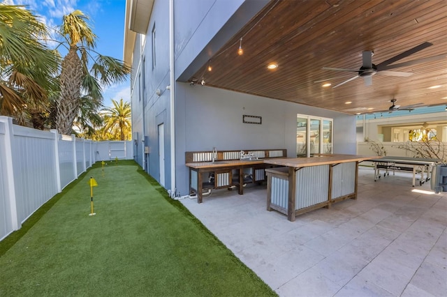 view of patio / terrace with a fenced backyard and a ceiling fan