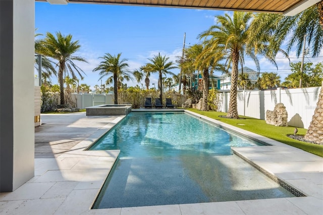 view of swimming pool with a patio area, a fenced backyard, and a pool with connected hot tub