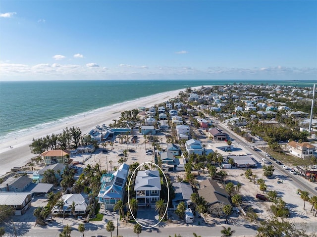 birds eye view of property with a view of the beach and a water view