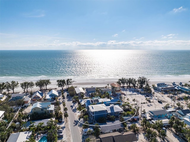 drone / aerial view with a view of the beach, a water view, and a residential view