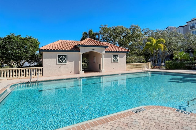 pool featuring a patio and fence