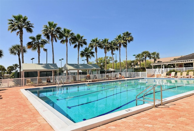 pool featuring a patio and fence