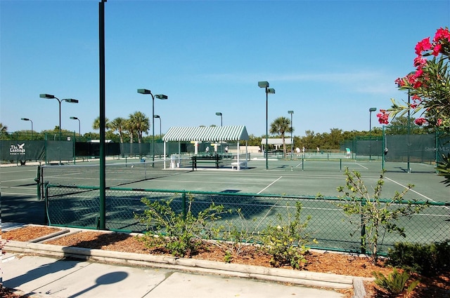 view of tennis court featuring fence