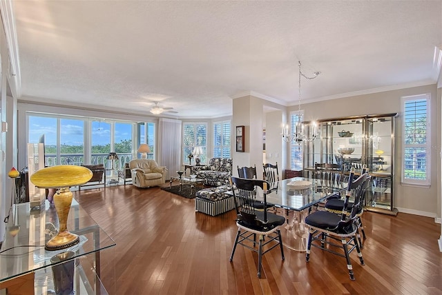 dining area featuring hardwood / wood-style flooring, plenty of natural light, and ornamental molding