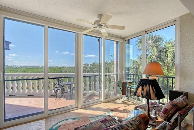 sunroom / solarium featuring a ceiling fan