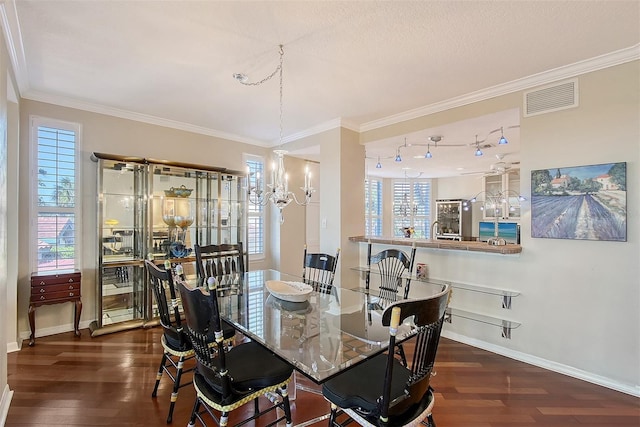 dining room with dark wood finished floors, visible vents, and plenty of natural light