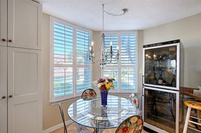 dining area with beverage cooler, a chandelier, and a wealth of natural light