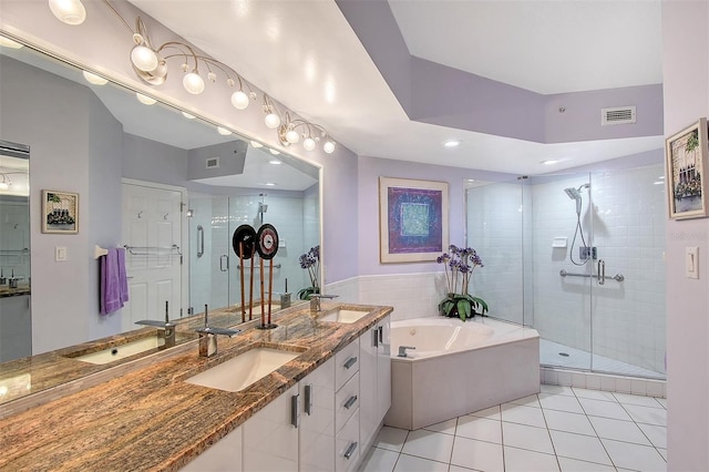 full bathroom with visible vents, a garden tub, and a sink