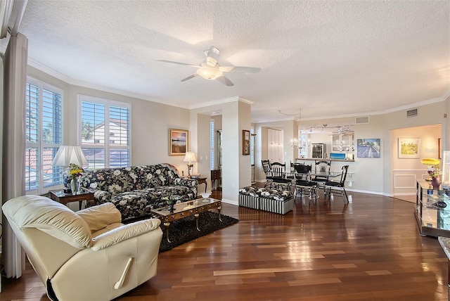 living area with visible vents, crown molding, wood finished floors, a textured ceiling, and a ceiling fan