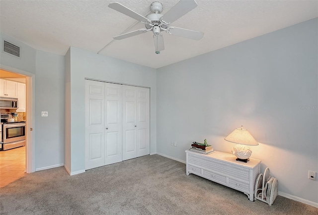 carpeted bedroom featuring visible vents, baseboards, and a closet