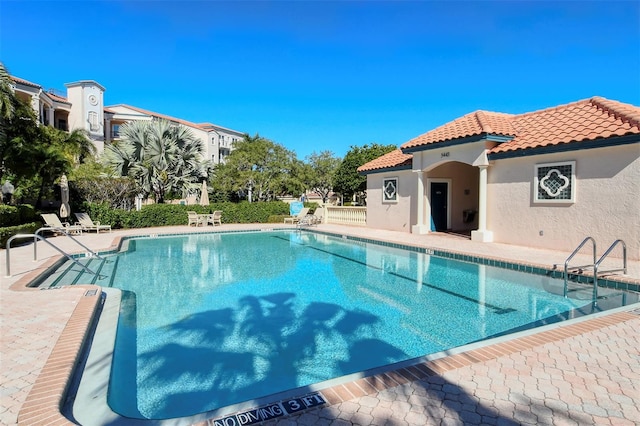 community pool with a patio area