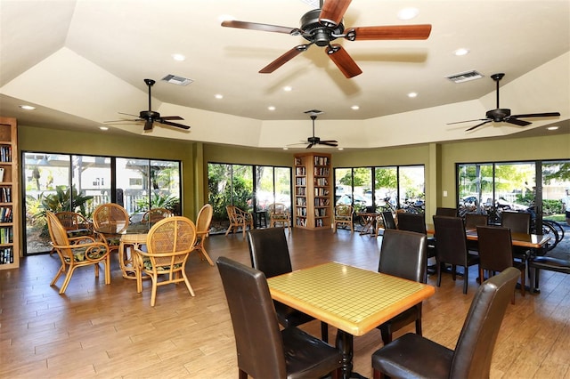 dining area featuring lofted ceiling, recessed lighting, light wood-style floors, and visible vents