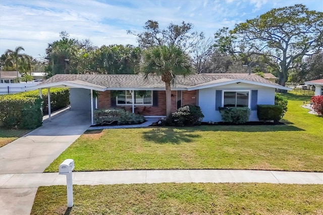 ranch-style house featuring a carport, a front yard, concrete driveway, and brick siding