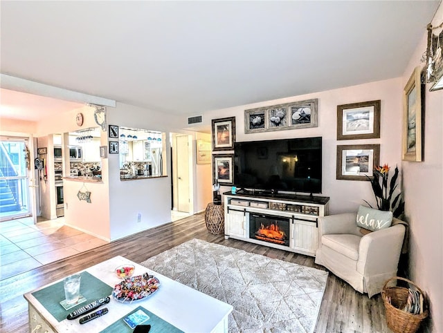 2057 Sunset Dr Unit G1, Bradenton, FL 34207 - living room with a fireplace, wood finished floors, and visible vents