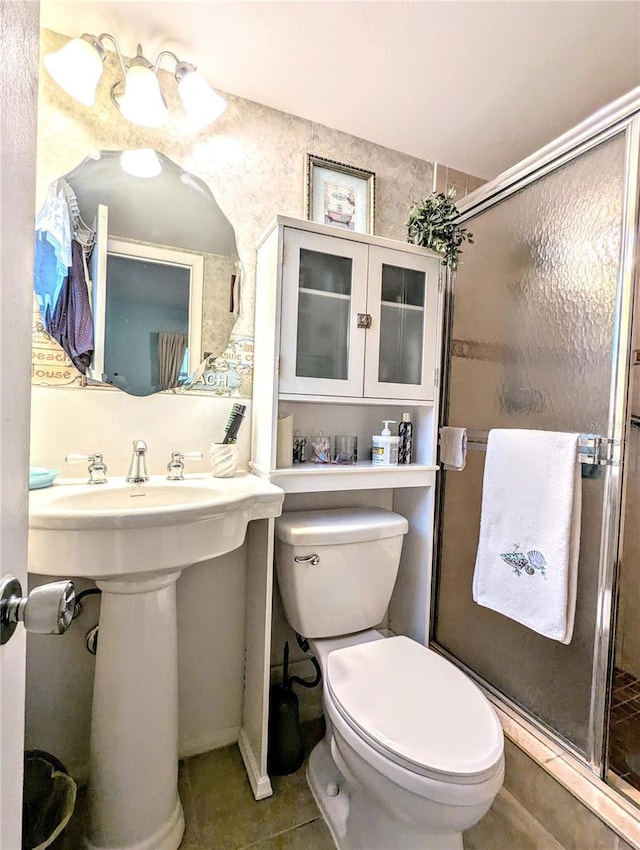 2057 Sunset Dr Unit G1, Bradenton, FL 34207 - full bathroom with a sink, a shower stall, toilet, and tile patterned floors