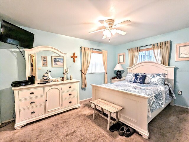 2057 Sunset Dr Unit G1, Bradenton, FL 34207 - bedroom with a ceiling fan, light carpet, and baseboards