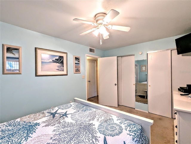 2057 Sunset Dr Unit G1, Bradenton, FL 34207 - bedroom with light carpet, ceiling fan, visible vents, and multiple closets