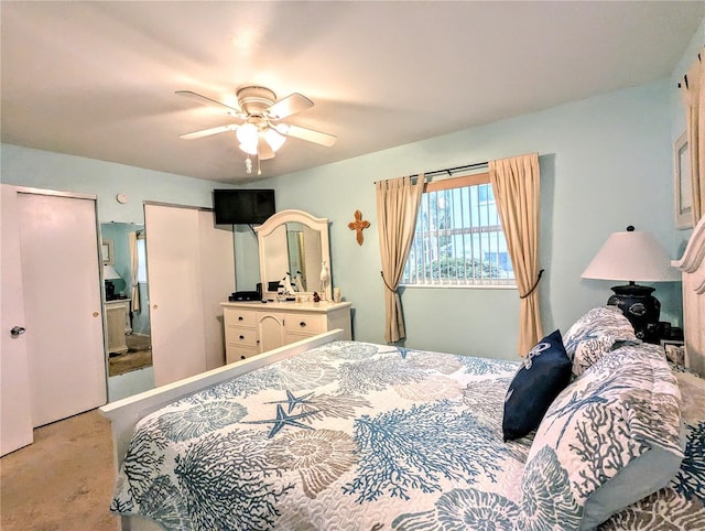 2057 Sunset Dr Unit G1, Bradenton, FL 34207 - bedroom featuring a ceiling fan, light colored carpet, and two closets