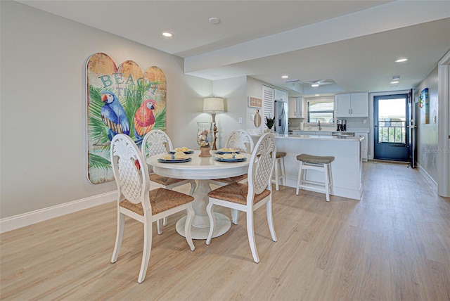 dining space featuring baseboards, recessed lighting, and light wood-style floors