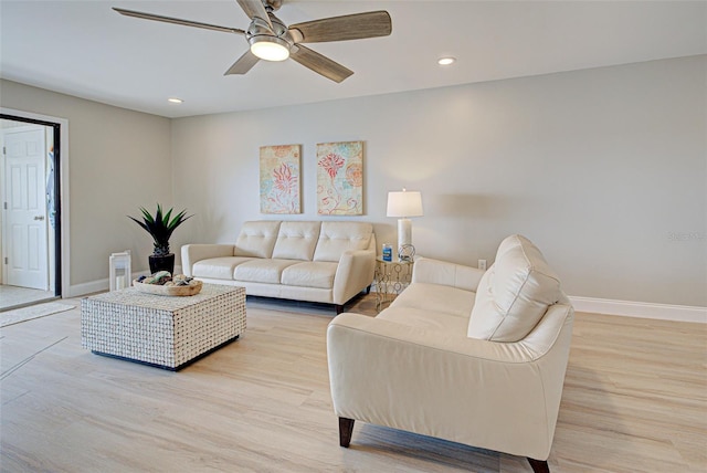 living room with recessed lighting, light wood finished floors, and baseboards