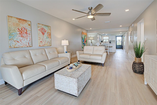 living area with recessed lighting, baseboards, ceiling fan, and light wood finished floors