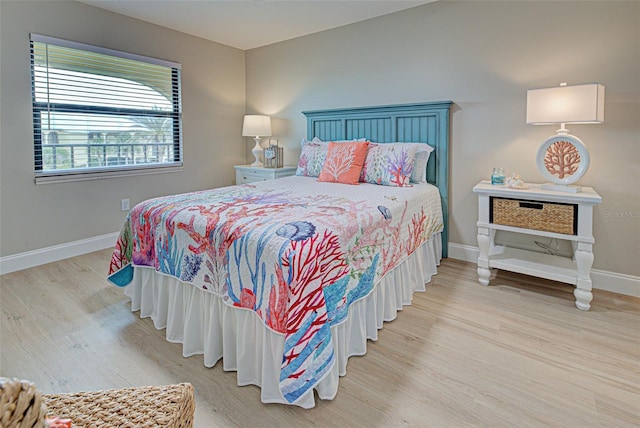 bedroom featuring baseboards and wood finished floors