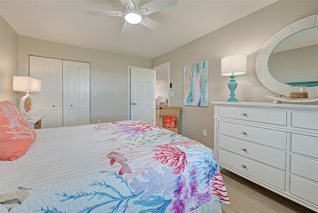 bedroom featuring ceiling fan, a closet, and wood finished floors