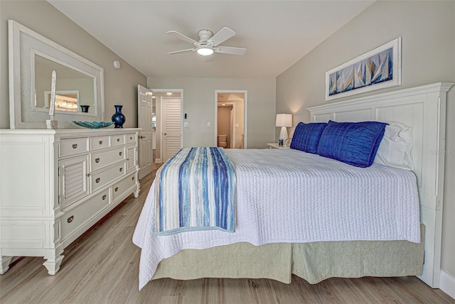 bedroom with connected bathroom, light wood-style flooring, and ceiling fan