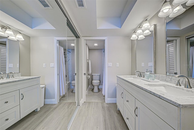 full bathroom featuring visible vents, a sink, and double vanity